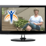 Video monitor with Springer Prosthetics "Bio" image, woman with prosthetic leg sitting in chair outdoors in back yard.