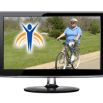 Video monitor with Springer Prosthetics "Let's Roll" image, woman riding bike on rural street.